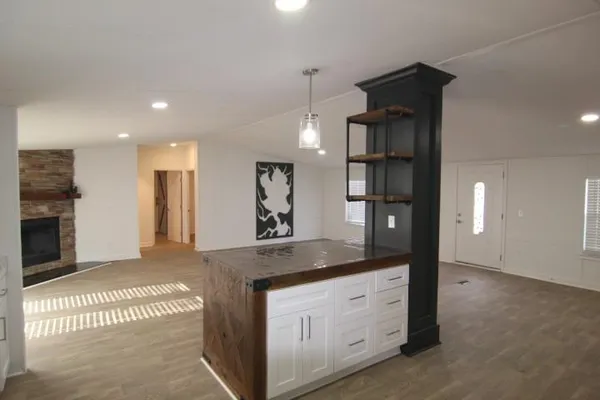 a spacious bathroom with a granite countertop sink a mirror and shower