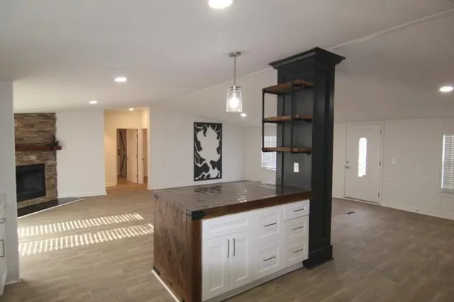 a spacious bathroom with a granite countertop sink a mirror and shower