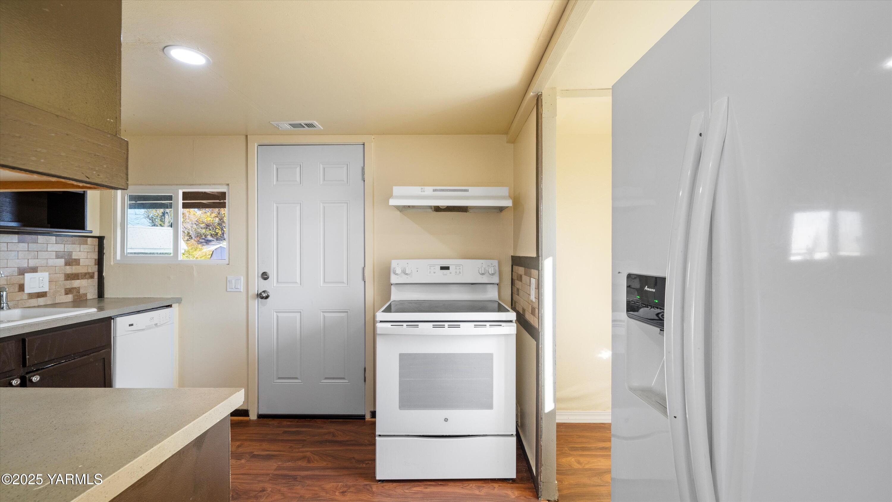 1802 Symons Street Richland, WA 99354 - Photo 7 of 23 a kitchen with a refrigerator and a stove