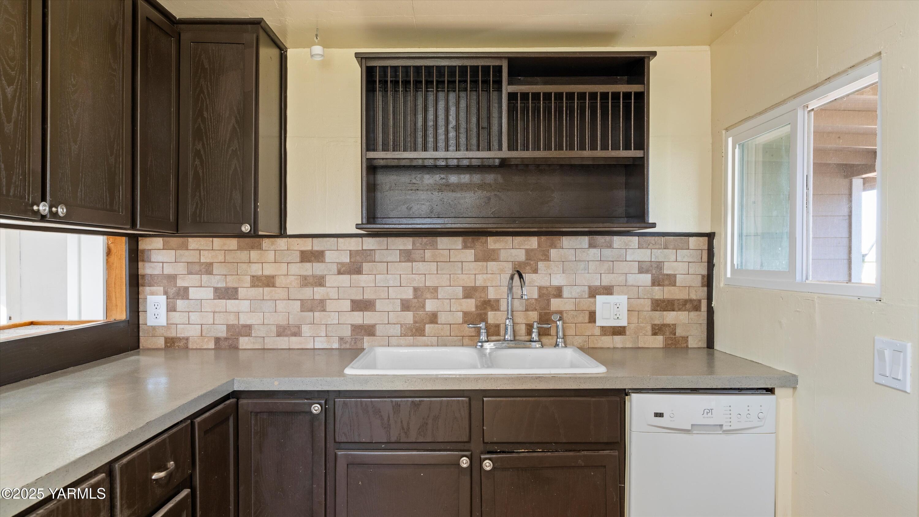 1802 Symons Street Richland, WA 99354 - Photo 9 of 23 a kitchen with a sink cabinets and a window