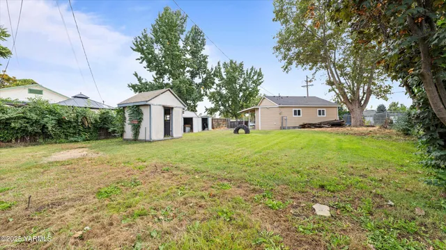 a front view of a house with yard and green space