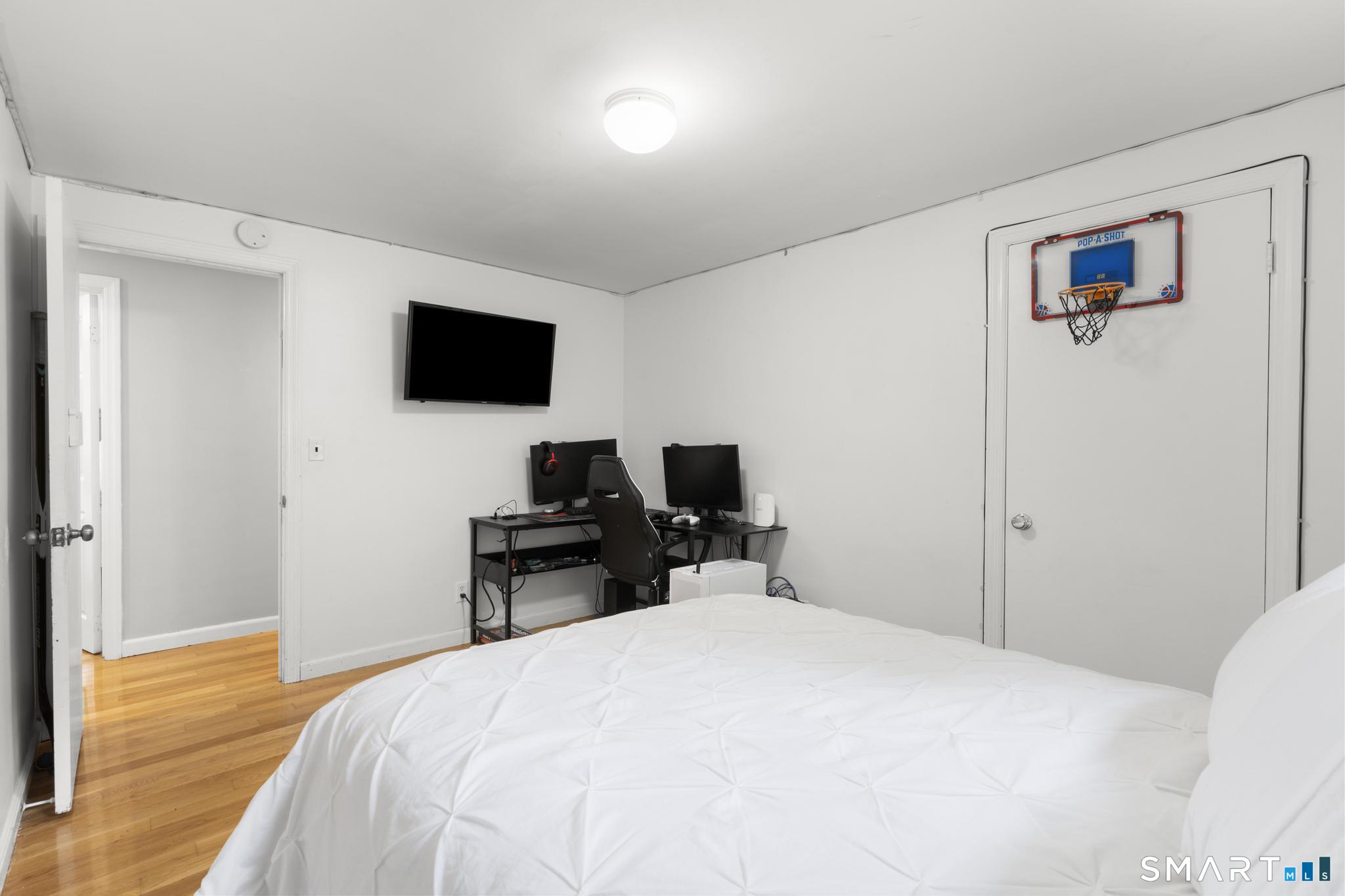 200 Old Huckleberry Road Wilton, CT 06897 - Photo 16 of 24 a bedroom with a bed and a flat screen tv
