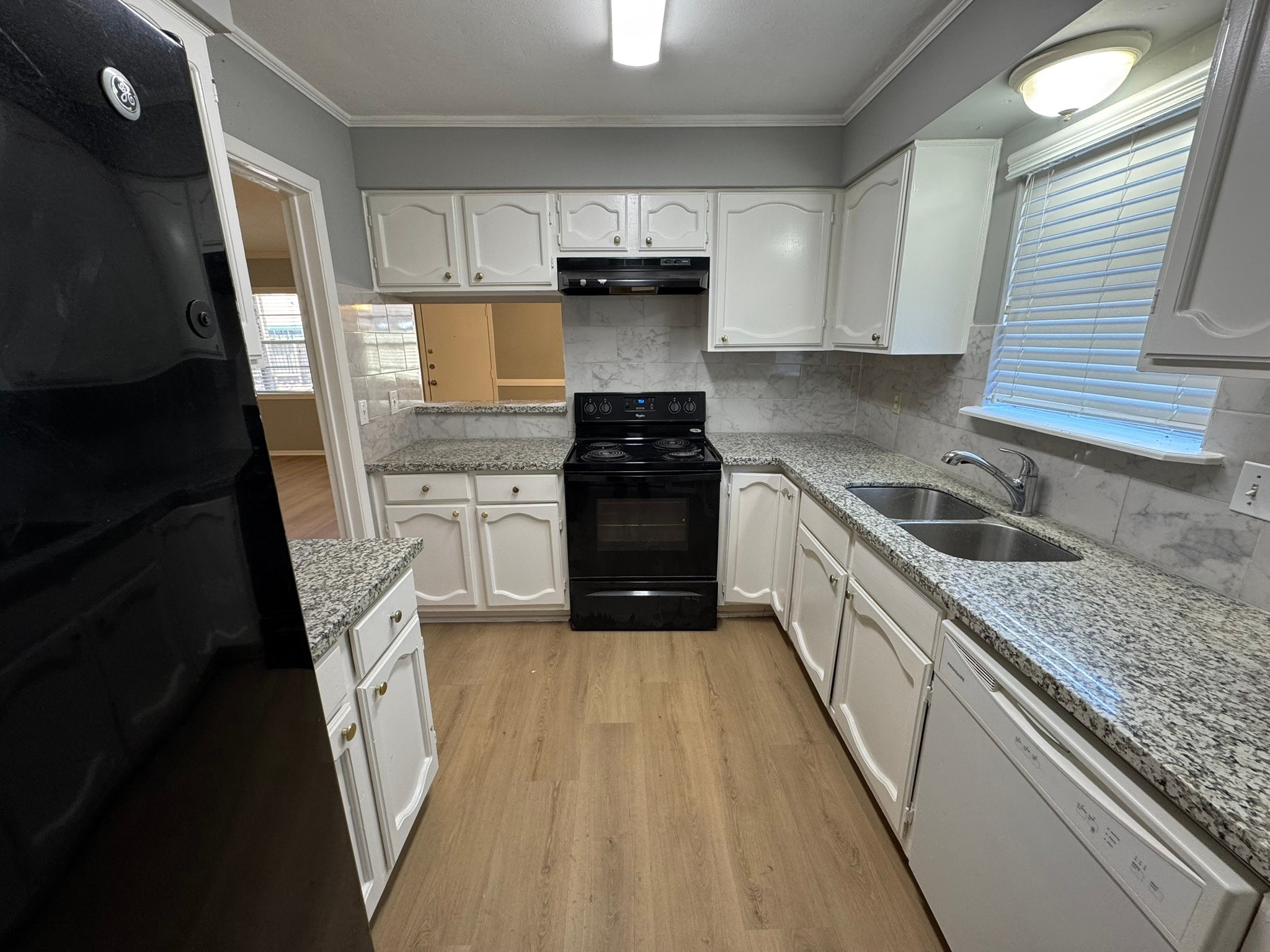 7231 Daylight Lane Houston, TX 77095 - Photo 3 of 11 a kitchen with a sink a stove and cabinets