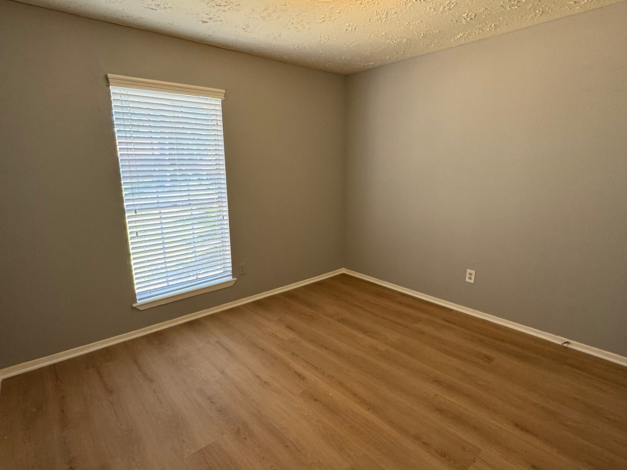 7231 Daylight Lane Houston, TX 77095 - Photo 9 of 11 an empty room with wooden floor and windows