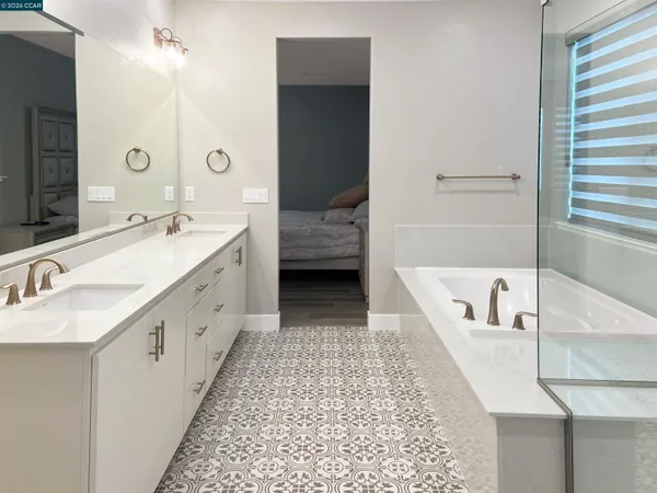 a bathroom with a tub sink and a mirror