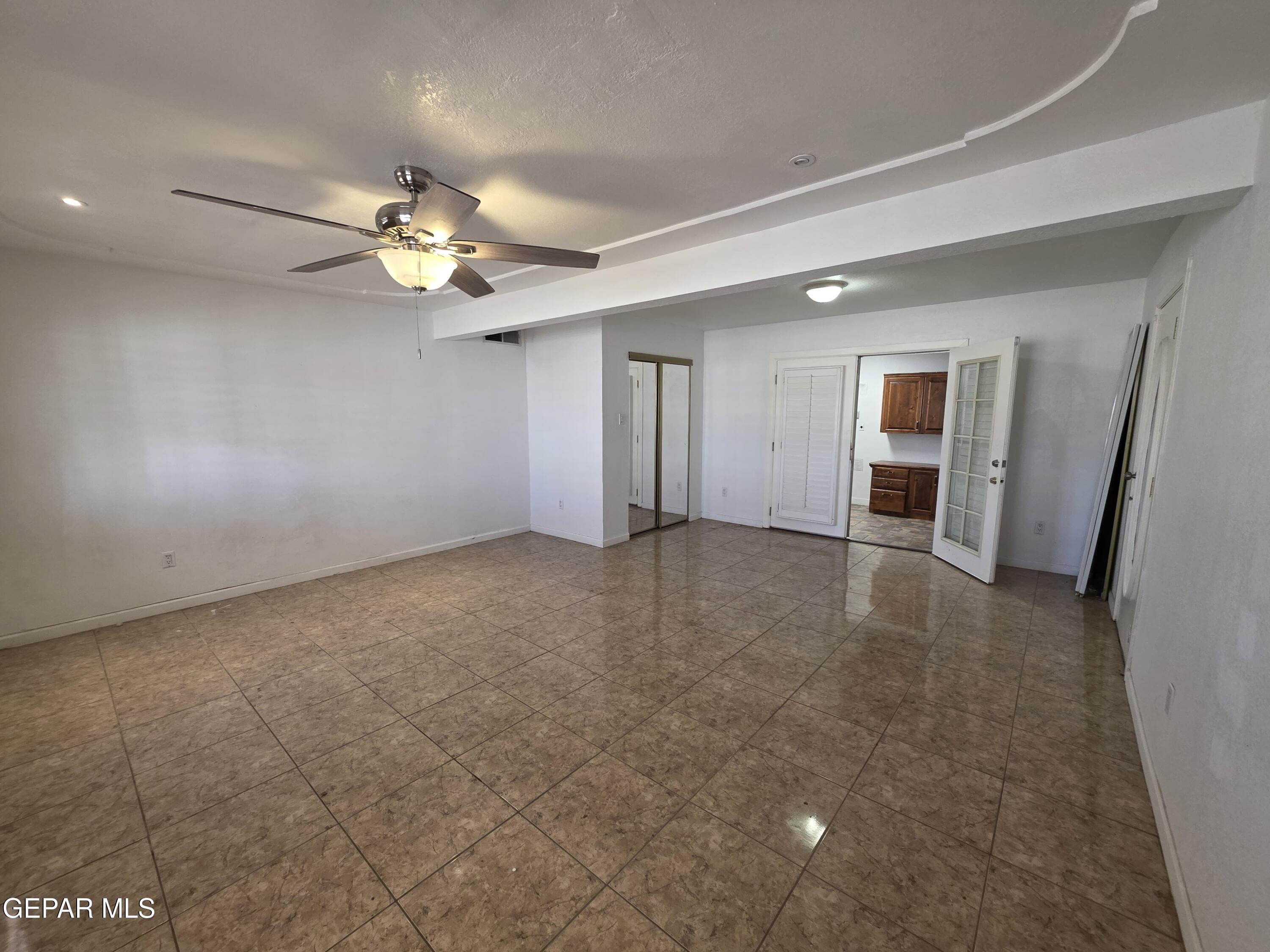 11661 Socorro Road Socorro, TX 79927 - Photo 14 of 33 a view of an empty room with a ceiling fan