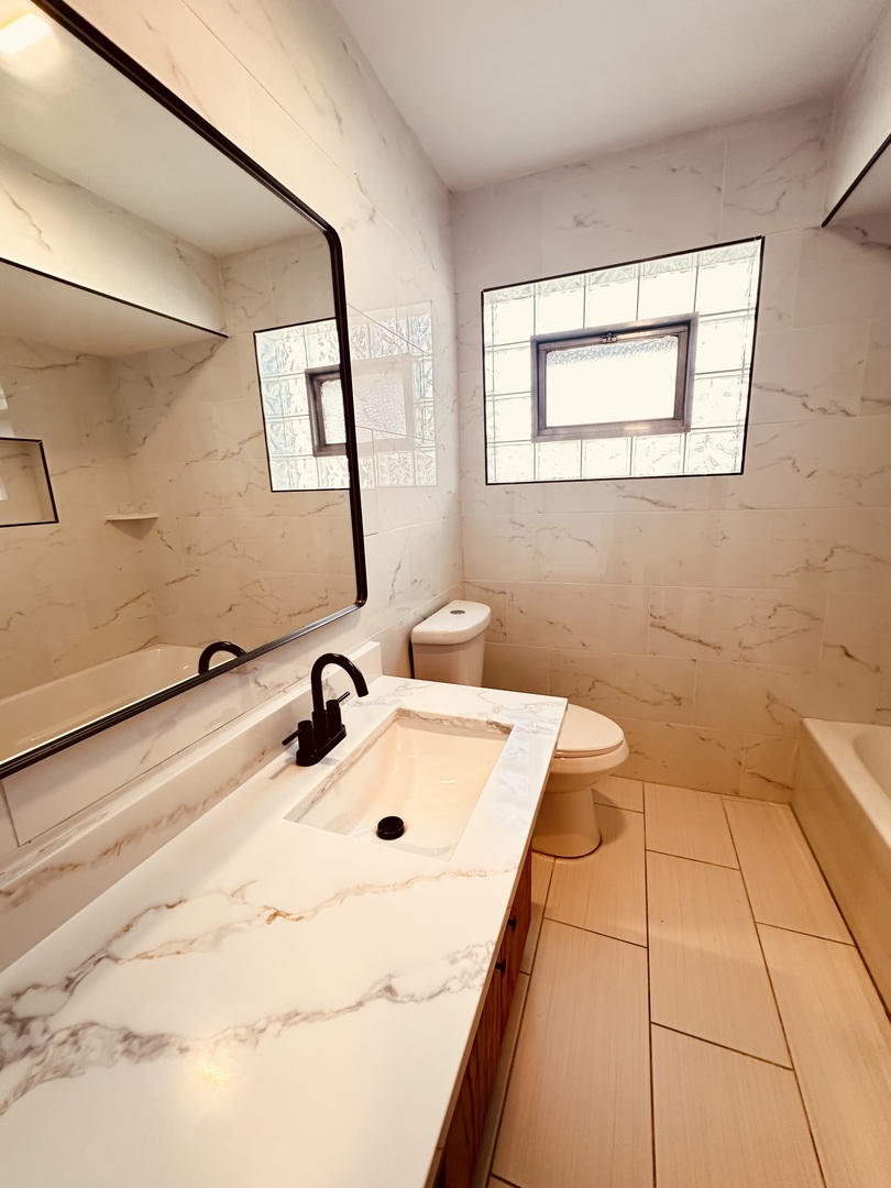 2823 West 71st Street Chicago, IL 60629 - Photo 13 of 18 a bathroom with a sink and a mirror
