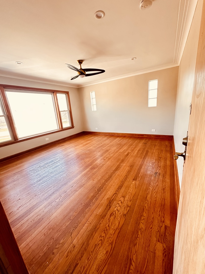 2823 West 71st Street Chicago, IL 60629 - Photo 2 of 18 a view of empty room with wooden floor and fan
