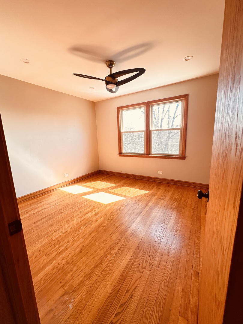 2823 West 71st Street Chicago, IL 60629 - Photo 9 of 18 a view of an empty room with wooden floor and a window