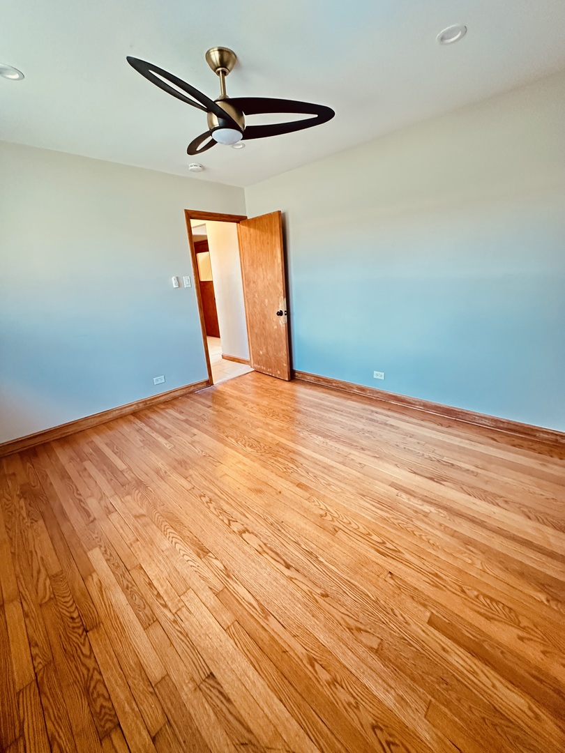 2823 West 71st Street Chicago, IL 60629 - Photo 10 of 18 a view of empty room with a ceiling fan