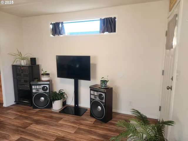 a view of a livingroom with furniture and a flat screen tv