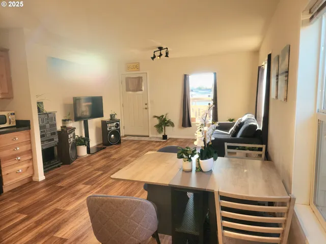 a view of a kitchen with kitchen island a counter top space appliances and cabinets