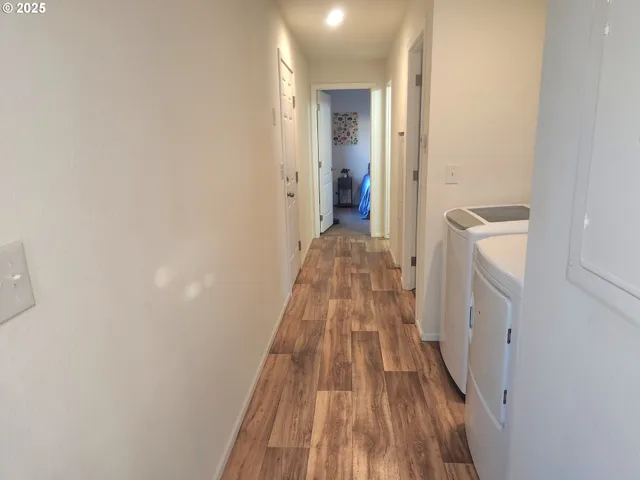 a bathroom with a sink and a wooden floor