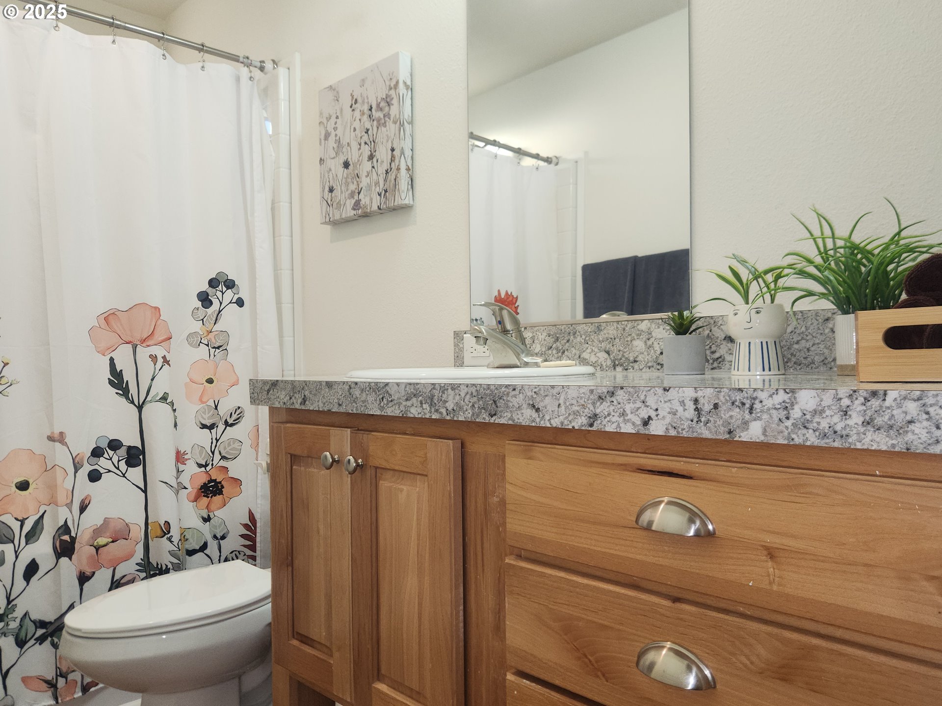515 Southeast Sheridan Road, Unit 6 Sheridan, OR 97378 - Photo 19 of 30 a bathroom with a granite countertop sink a toilet and a mirror