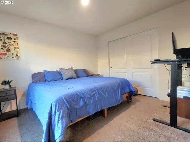 a bedroom with a bed and a view of bedroom