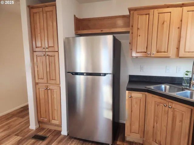 a kitchen with metallic refrigerator freezer and a dishwasher