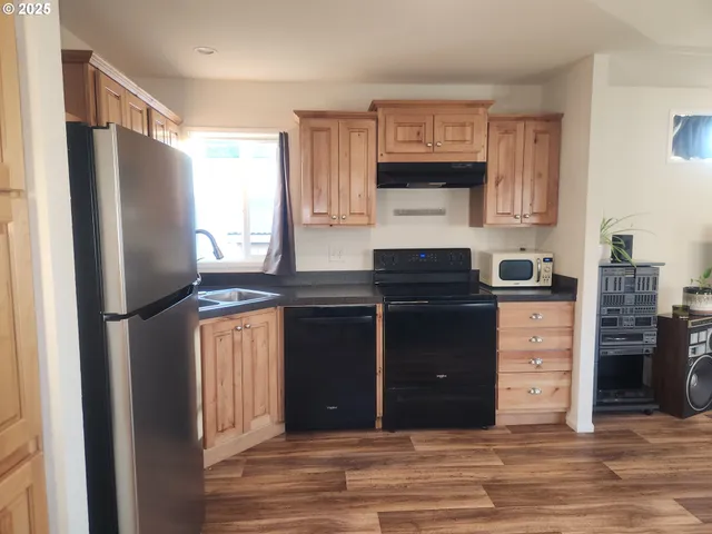 a kitchen with stainless steel appliances granite countertop a refrigerator and a stove