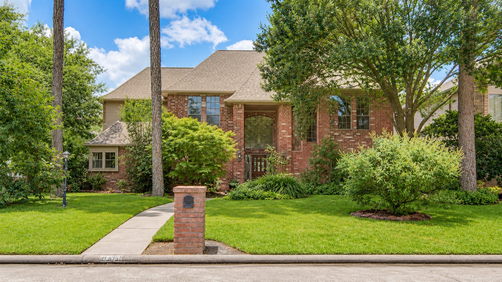 8412 Hidden Trail Lane Spring, TX 77379 - Photo 1 of 43 A view of the front façade highlights the mature trees and inviting approach to this well-maintained home with pool and spa.