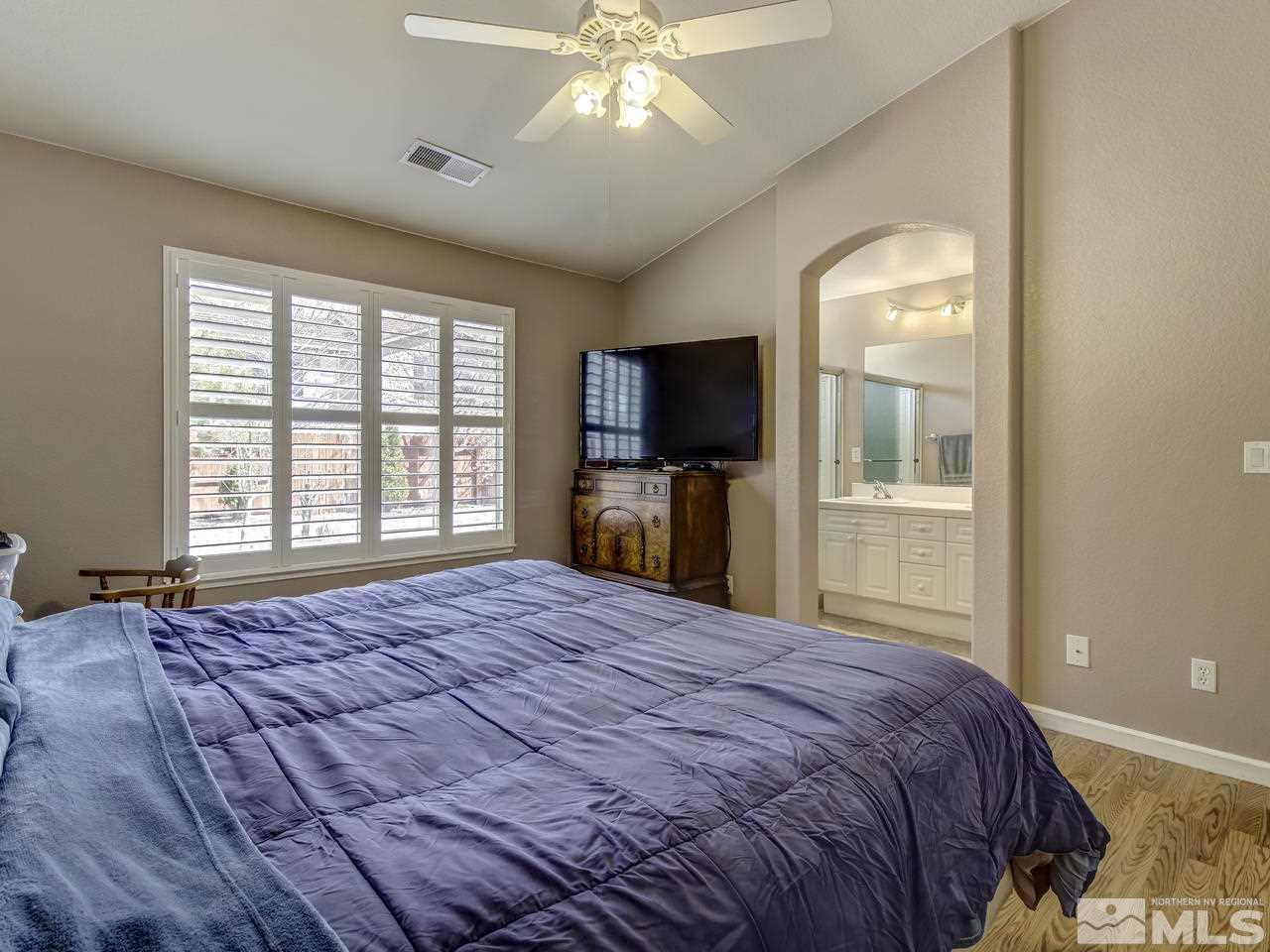 1789 River Gorge Drive Reno, NV 89521 - Photo 13 of 24 a bedroom with a large bed and a flat tv screen on dresser