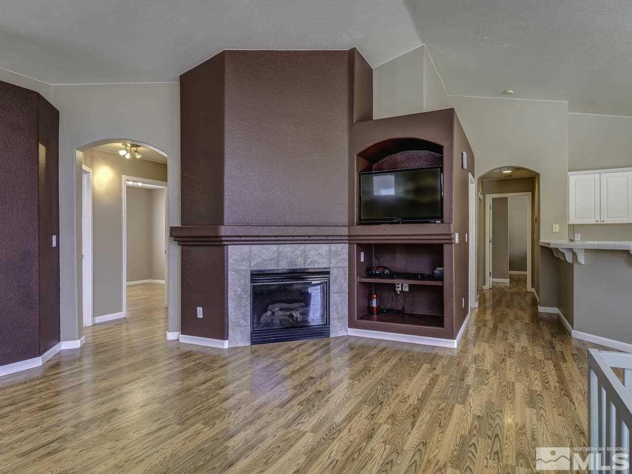 1789 River Gorge Drive Reno, NV 89521 - Photo 5 of 24 a living room with a fireplace and a television