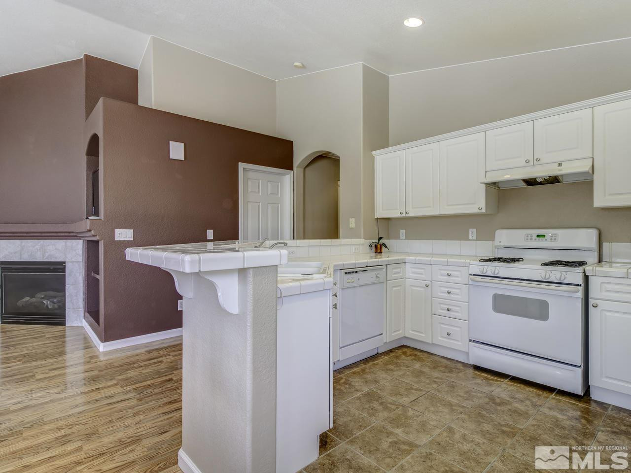1789 River Gorge Drive Reno, NV 89521 - Photo 7 of 24 a kitchen with a sink stove and cabinets