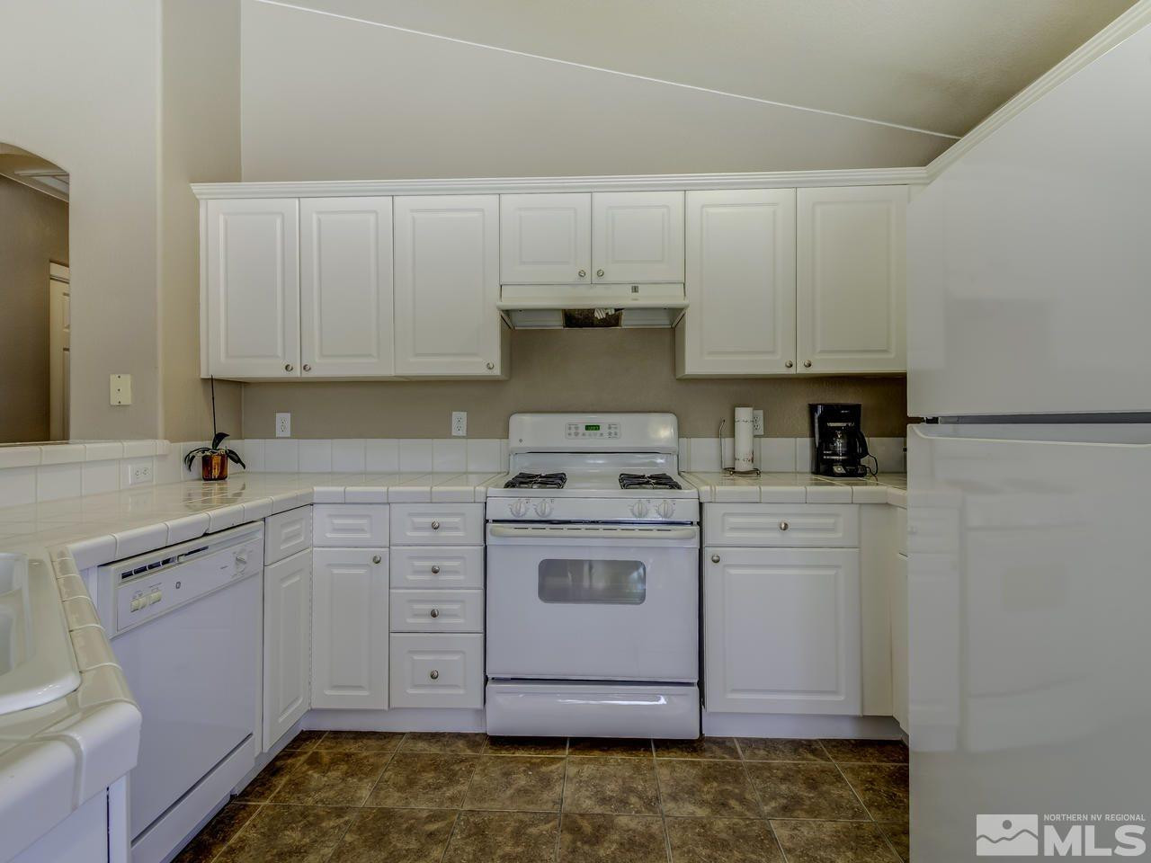 1789 River Gorge Drive Reno, NV 89521 - Photo 9 of 24 a kitchen with cabinets appliances and a sink