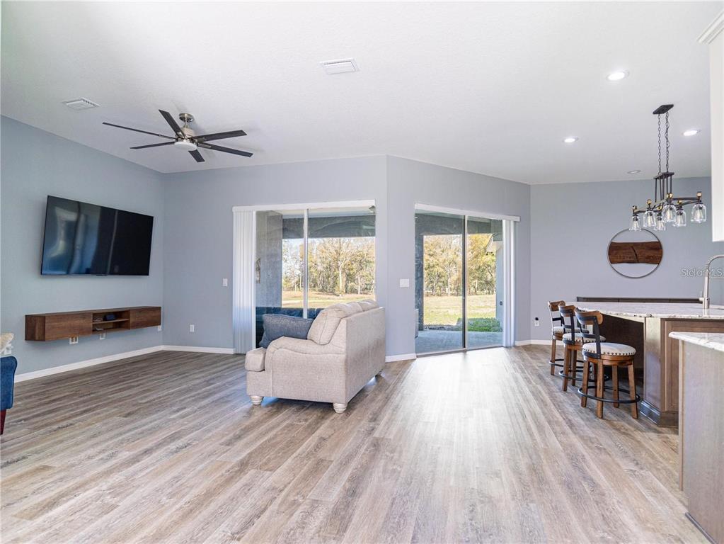 10688 Southwest 129th Terrace Road Dunnellon, FL 34432 - Photo 13 of 35 a living room with furniture and a wooden floor