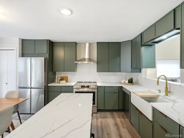 a kitchen with a sink a refrigerator and cabinets