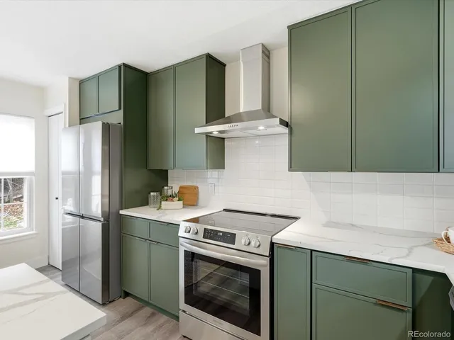 a kitchen with stainless steel appliances a refrigerator sink and cabinets