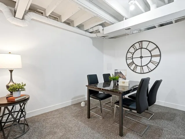a view of a workspace room with furniture and wooden floor