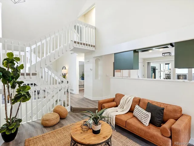 a living room with furniture and flowers
