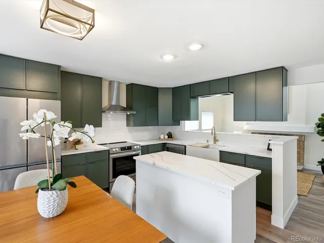 a kitchen with stainless steel appliances kitchen island granite countertop a sink and cabinets