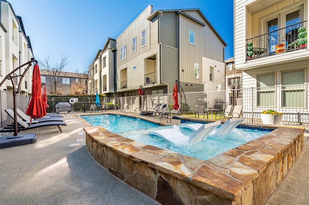 4211 Rawlins Street, Unit 528 Dallas, TX 75219 - Photo 13 of 14 Outdoor swimming pool with an integrated spa featuring stone coping, surrounded by a concrete deck