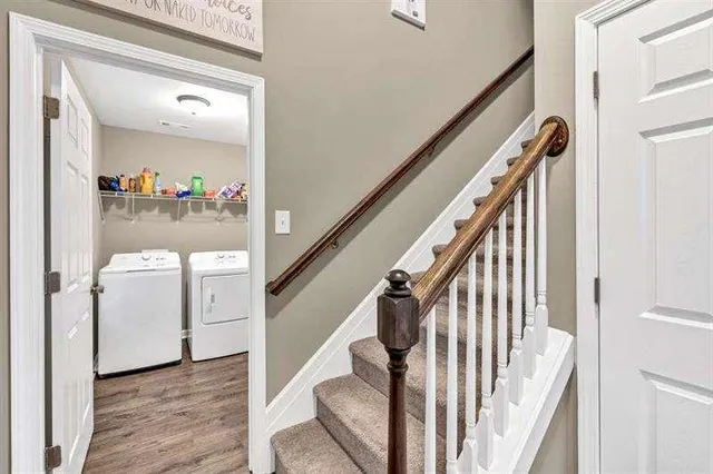 a view of hallway with stairs and furniture