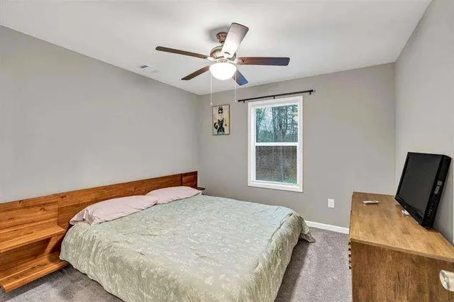 a bedroom with a bed and window