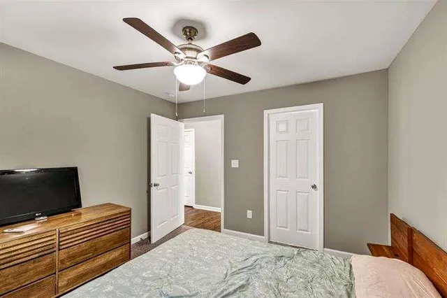 a bedroom with a bed and a dresser