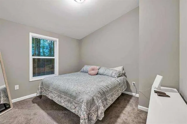 a bedroom with a bed and window