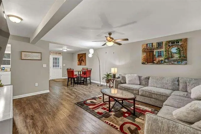 a living room with furniture and wooden floor
