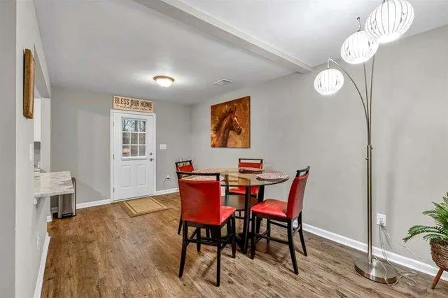 a view of a dining room with furniture window and wooden floor
