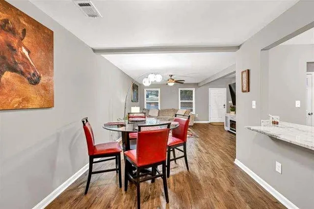 a view of a dining room with furniture and wooden floor