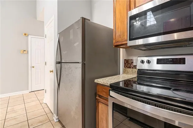 a metallic refrigerator freezer sitting in a kitchen