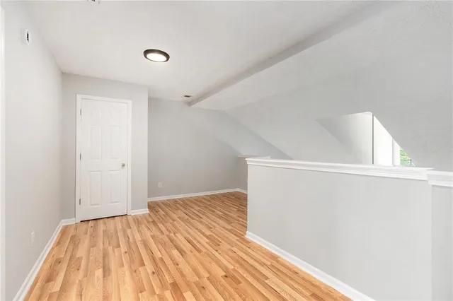 a view of a room with wooden floor