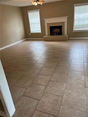 an empty room with fireplace and windows