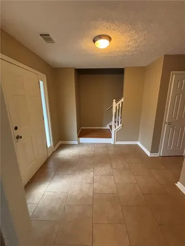 a view of a livingroom with a furniture and stairs