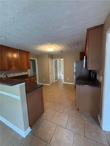 a view of kitchen with furniture and a refrigerator
