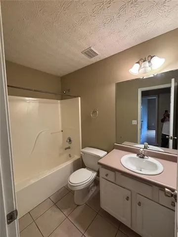 a bathroom with a double vanity sink toilet mirror and bathtub