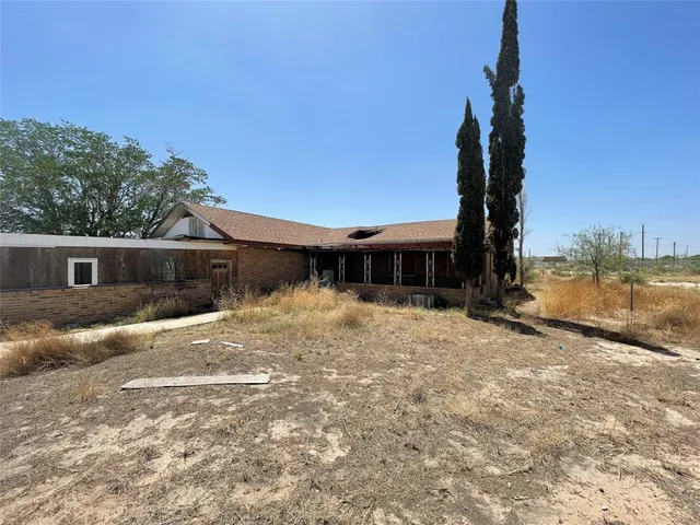 a view of a wooden house with a yard