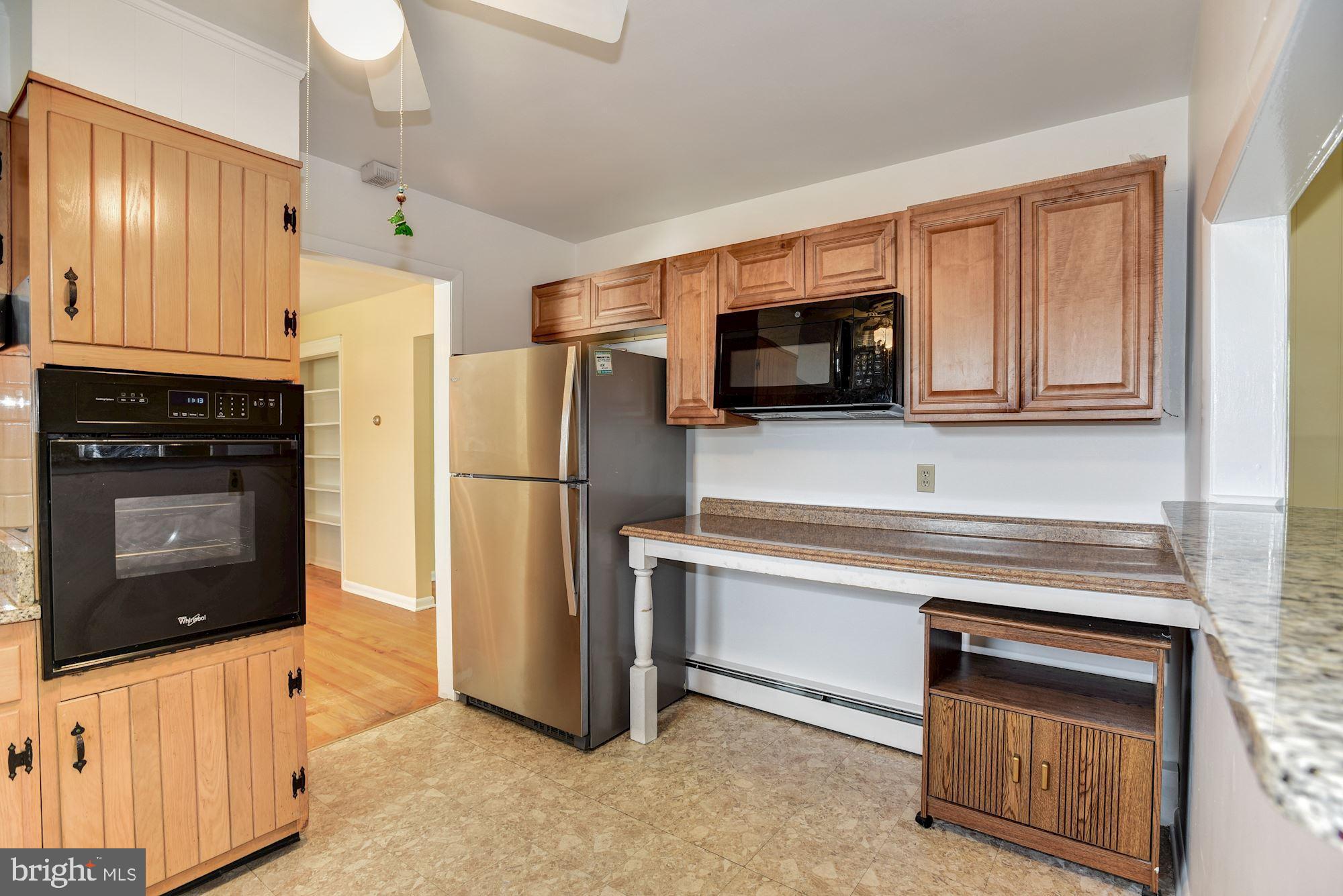 8492 Laurel Road Pasadena, MD 21122 - Photo 11 of 46 a kitchen with stainless steel appliances a stove microwave and refrigerator