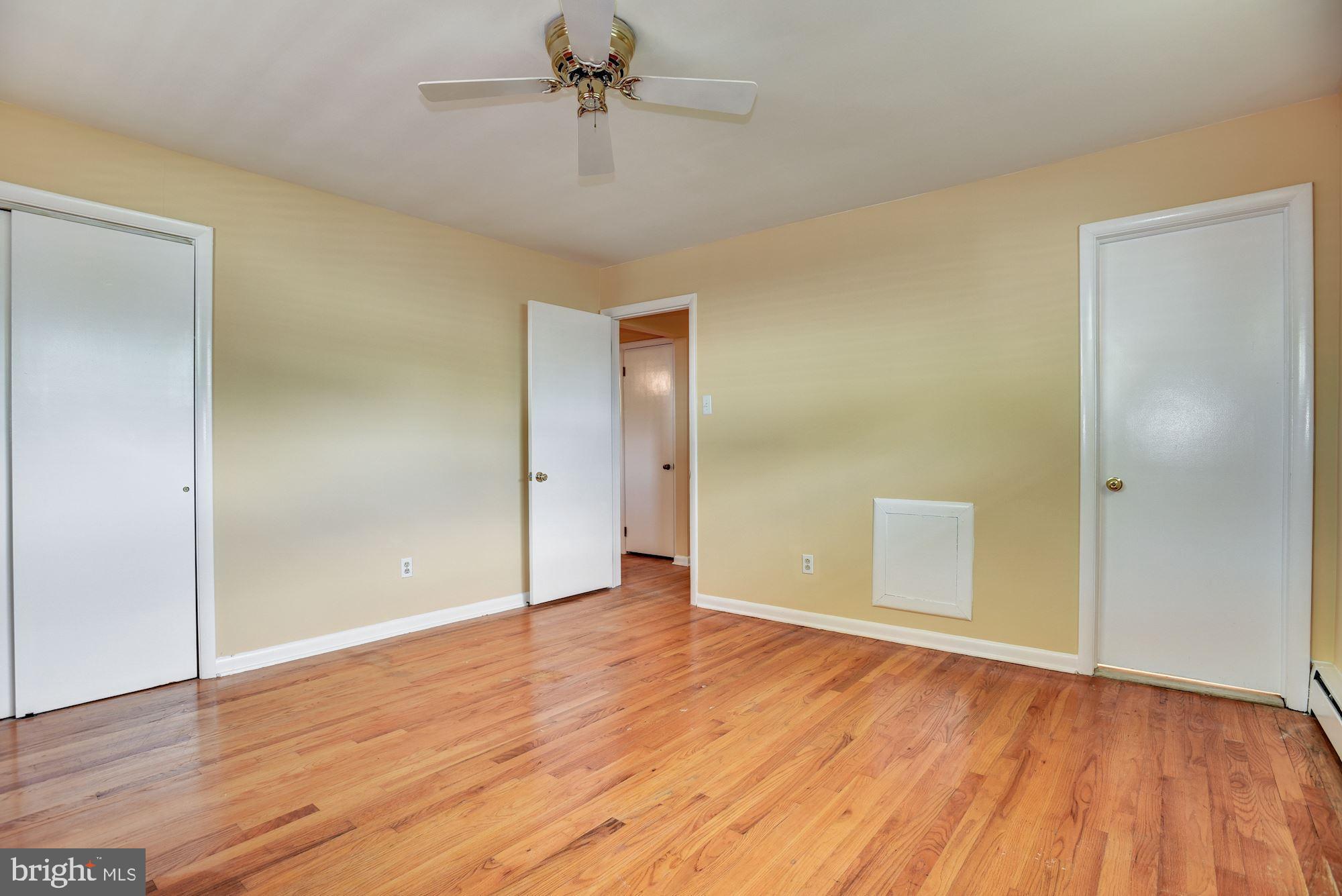 8492 Laurel Road Pasadena, MD 21122 - Photo 16 of 46 a view of an empty room with wooden floor