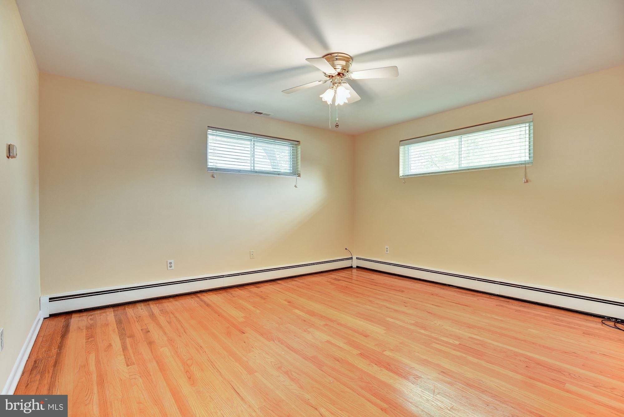 8492 Laurel Road Pasadena, MD 21122 - Photo 18 of 46 a view of an empty room with wooden floor